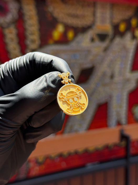 Original photo of the 24K Anime Inspired Double Sided Pendant held in a black glove