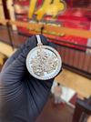 Original photograph of the 18K Haiti coat of arms pendant with diamond halo and diamond bail