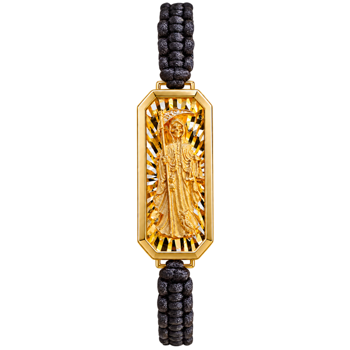 Upright Santa Muerte gold charm on black braided nylon bracelet, transparent background