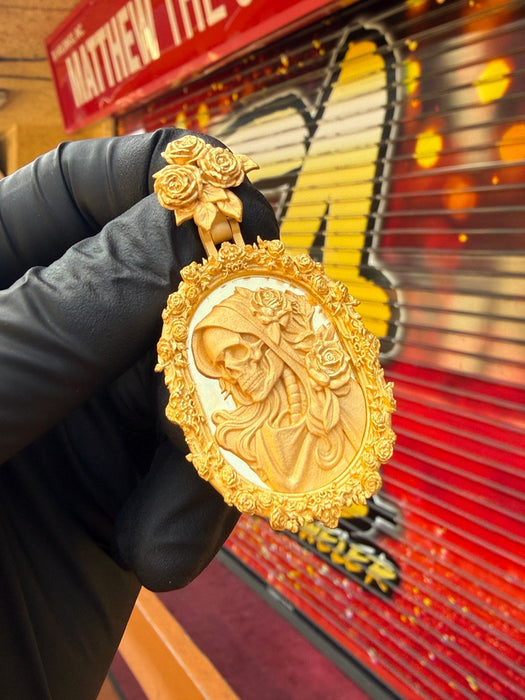 Original front photograph of the 22K Santa Muerte rose frame pendant